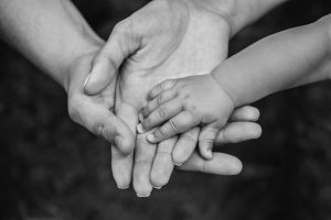 A family holding hands in black and white